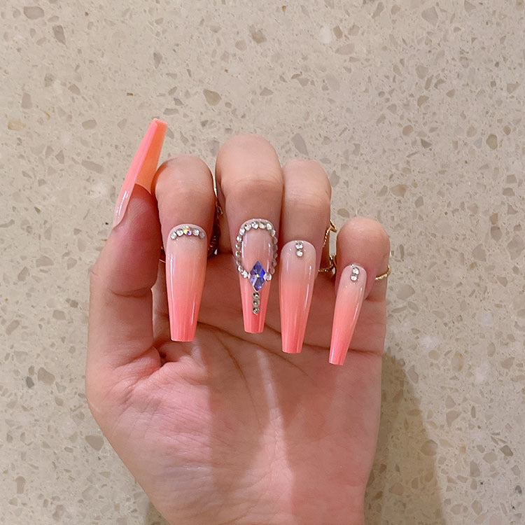 Artificial nails with glitter and stone embellishments Bowlift