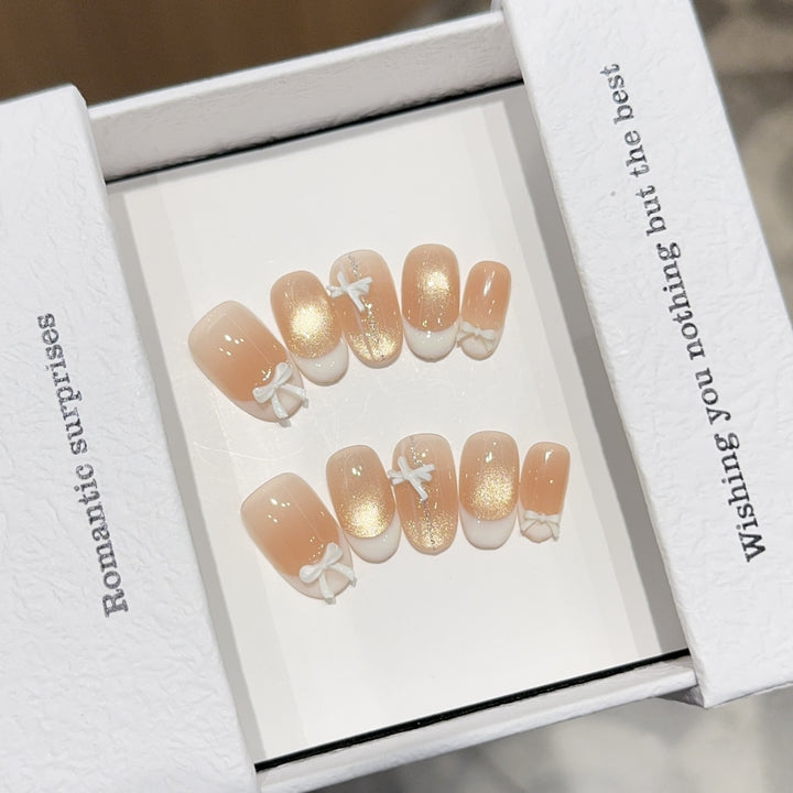 Artificial nails with romantic bow and glitter effects Bowlift
