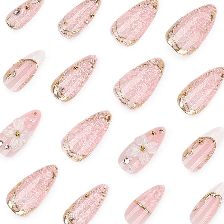 Artful nail extensions with delicate flower and gold embellishments Bowlift