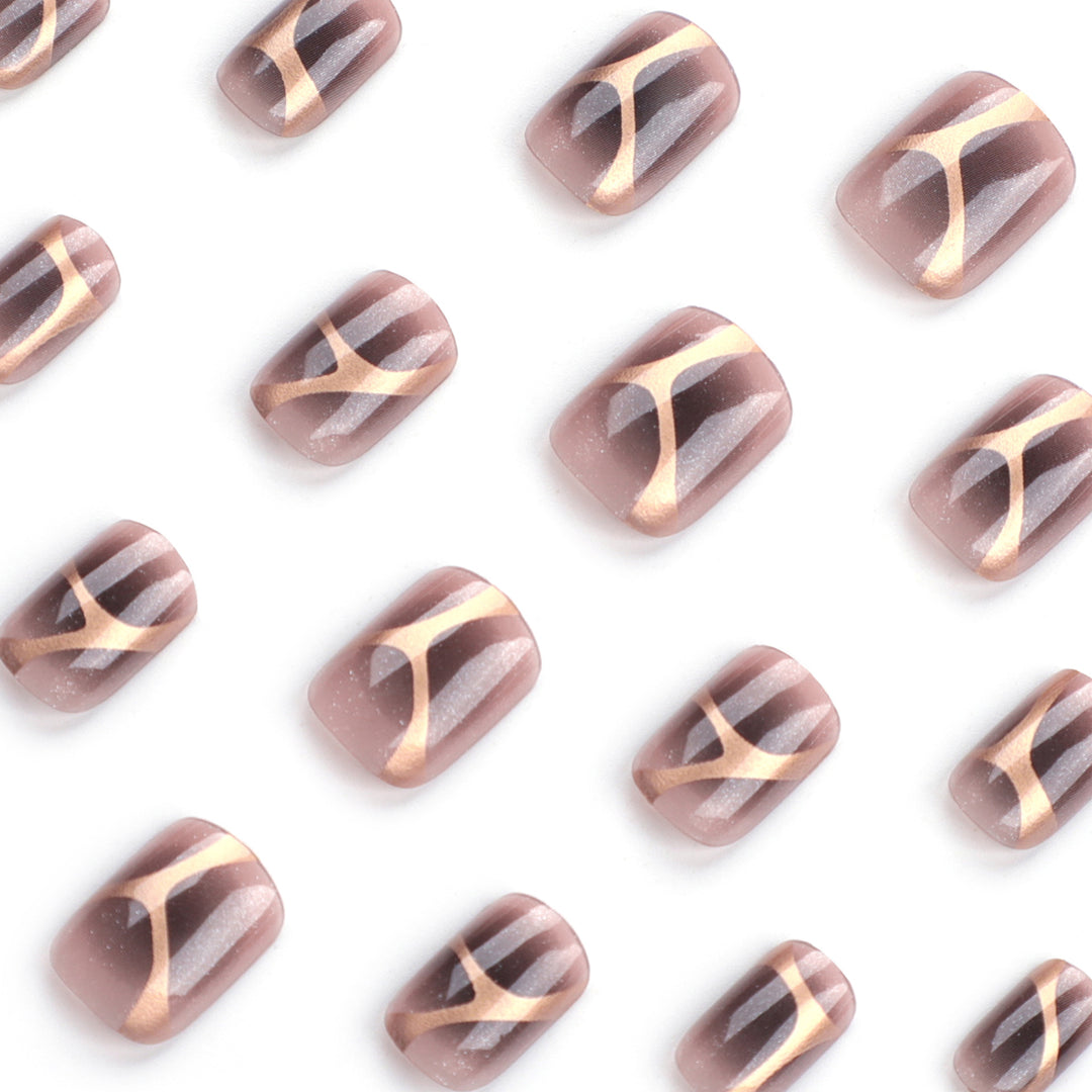 Artificial nail art with elegant metallic design and glitter accents Bowlift