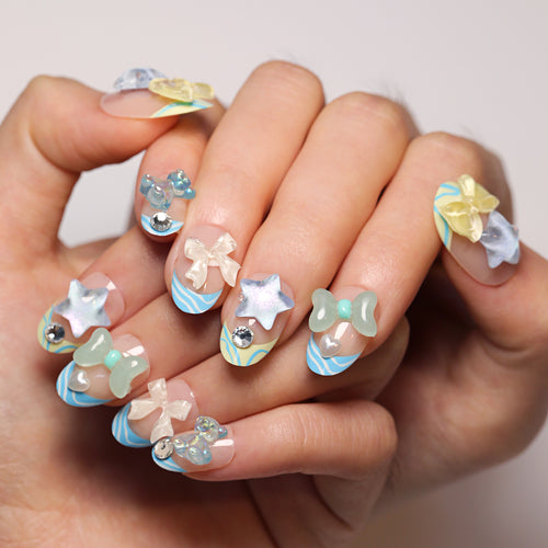 Artificial nail art with colorful pastel designs and 3D embellishments Bowlift
