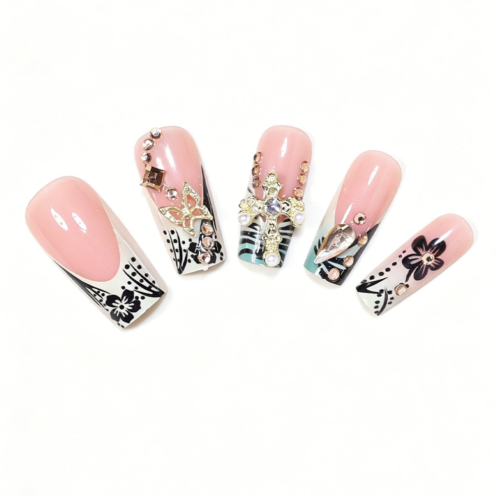 Artistic Stiletto Nail Design with Floral Accents and Gems Bowlift