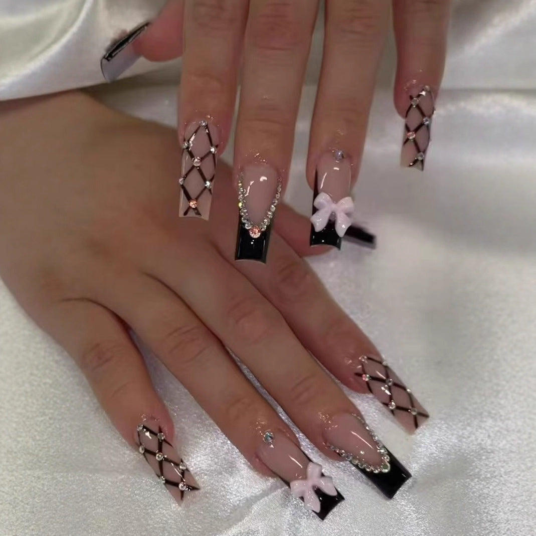 Artificial nail set with glamorous rhinestone and bow accents Bowlift