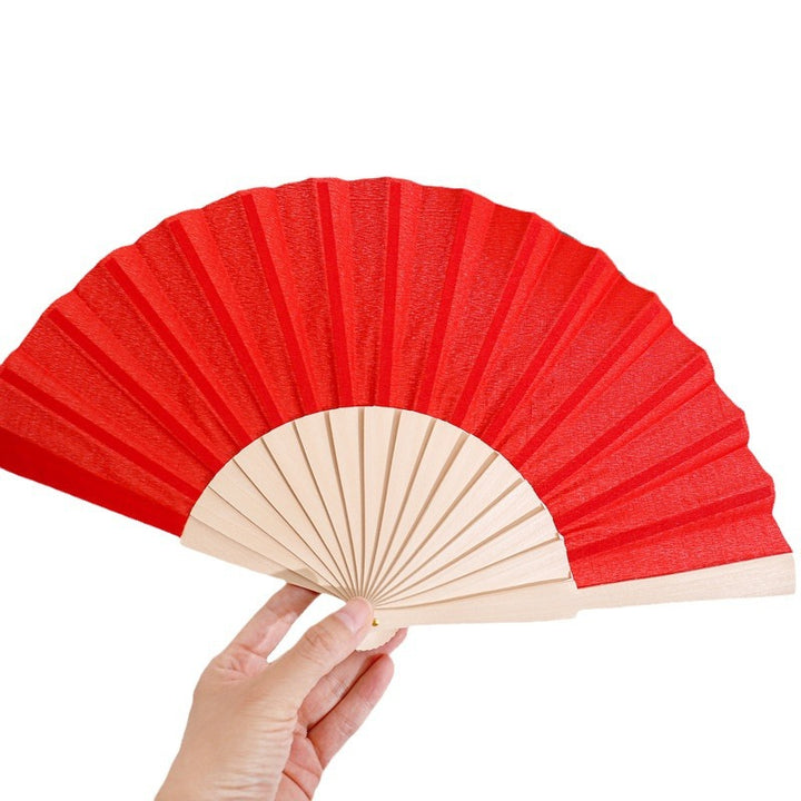 Ladies folding hand fan made of airy material with intricate folds Bowlift