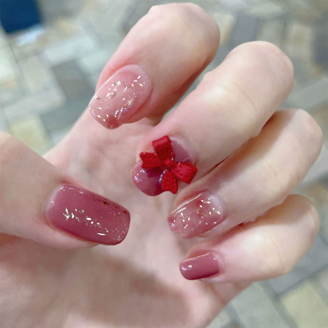 Artificial nail art with glitter embellishments and cute bow motif Bowlift