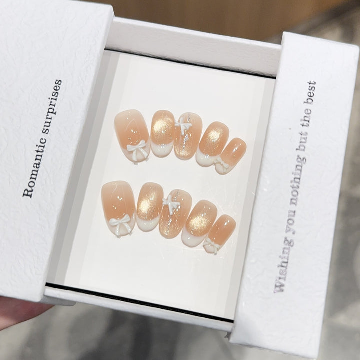 Artificial nails with romantic bow and glitter effects Bowlift