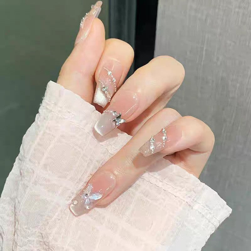 Artificial nails with glamorous decorations and shine Bowlift
