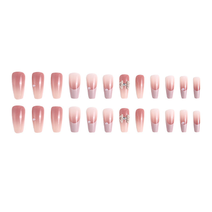 Artificial nail set with elegant ombre design and delicate bow embellishments Bowlift
