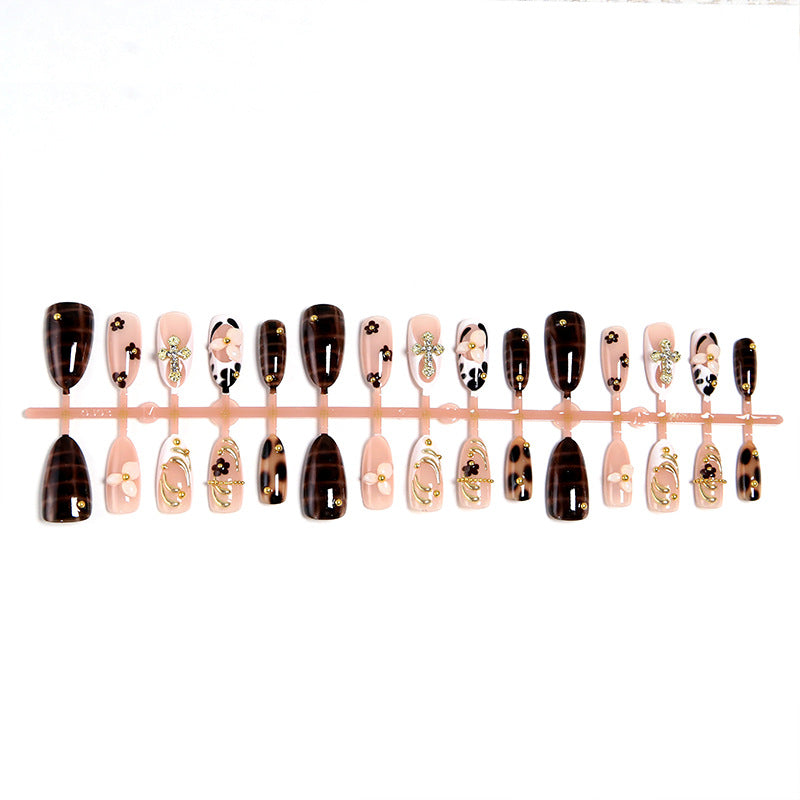 Artificial nails set with elegant gold accents and floral embellishments Bowlift