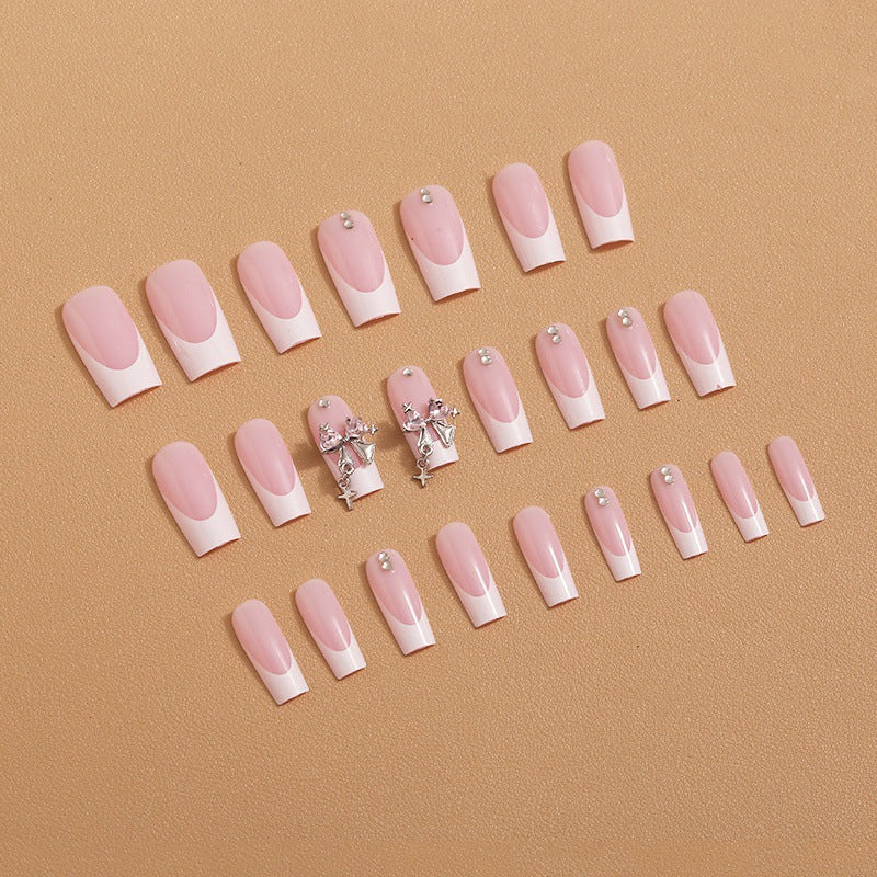 Artificial nail set with luxurious French tips and elegant embellishments Bowlift