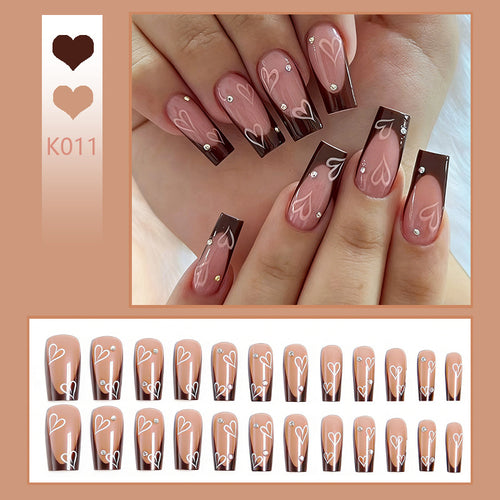 Elegant artificial nails with heart pattern and glitter accents Bowlift