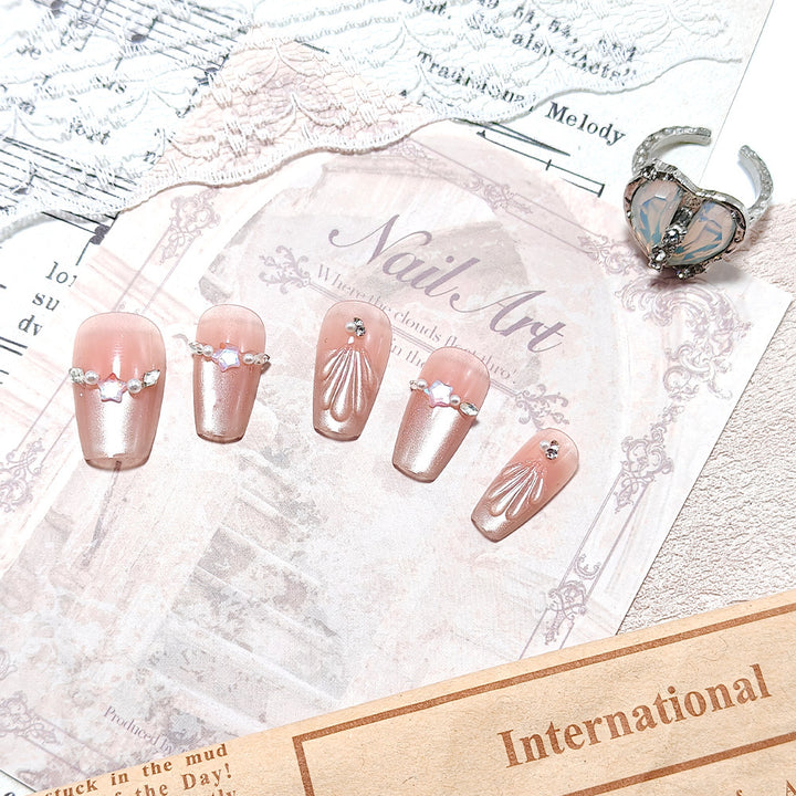 Elegant artificial nails with pearl and rhinestone embellishments Bowlift