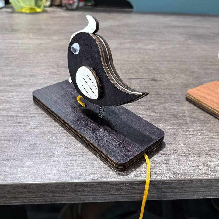 Unisex nan movable wooden bird table figure made of plywood with spiral spring and pull line Bowlift