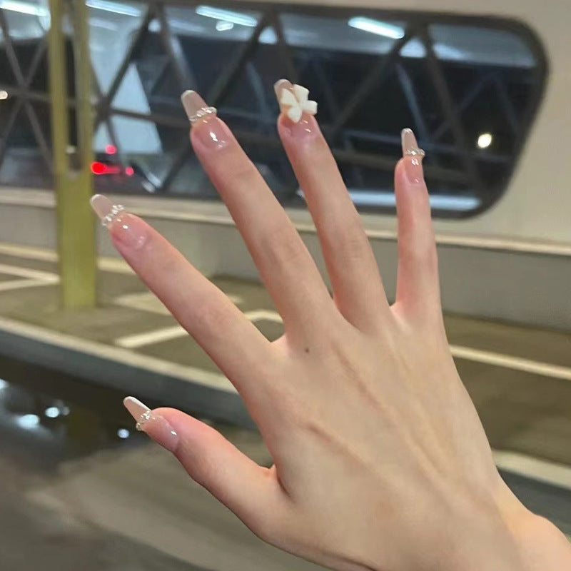 Artificial nails with elegant bow accents and pearl decorations Bowlift