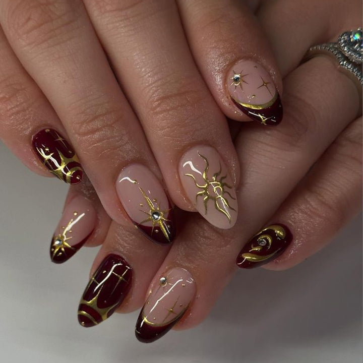 Artful nail art with golden accents and mystical motifs Bowlift