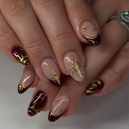 Artful nail art with golden accents and mystical motifs Bowlift