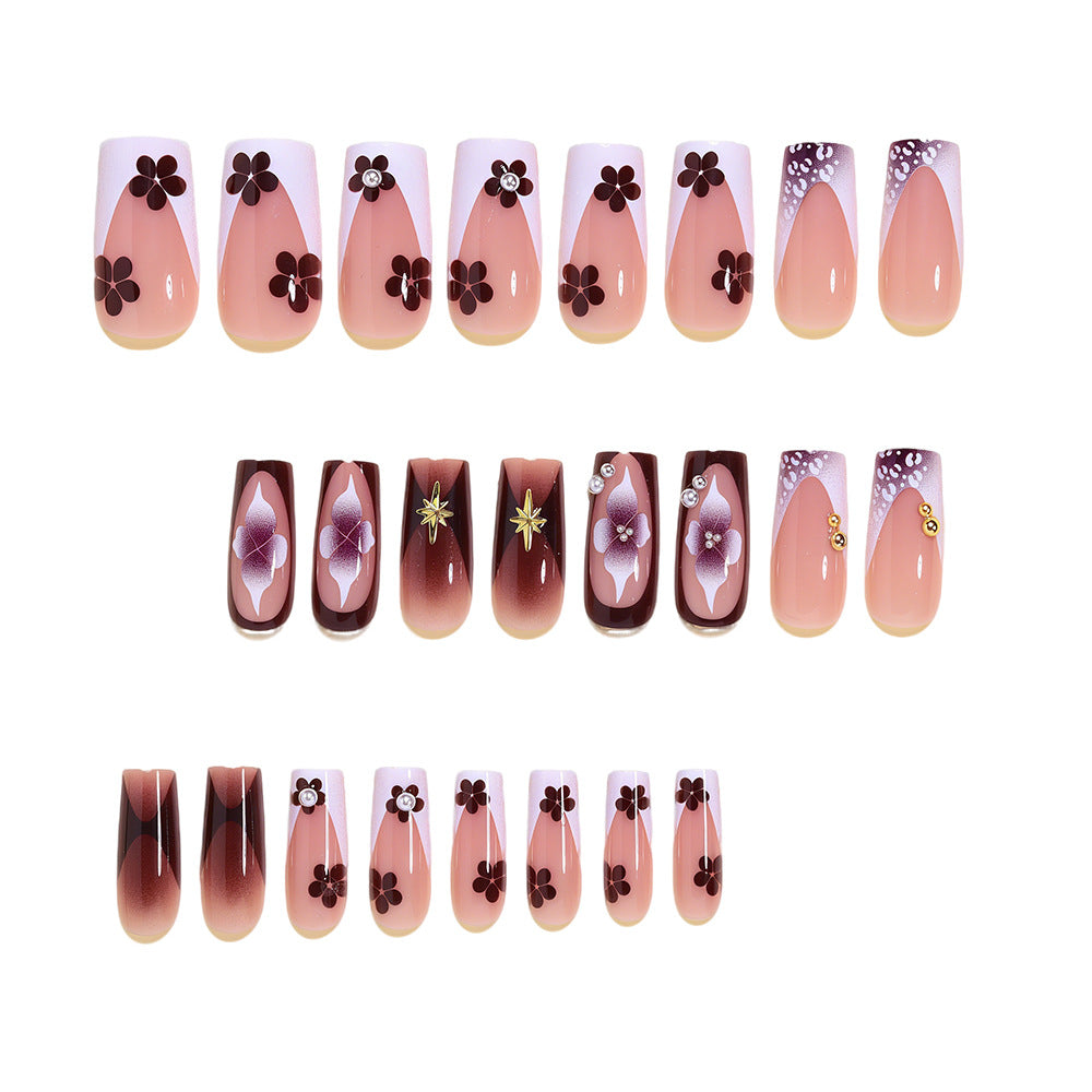 Artistic Acrylic Nail Design Set with Floral and Gold Accents Bowlift