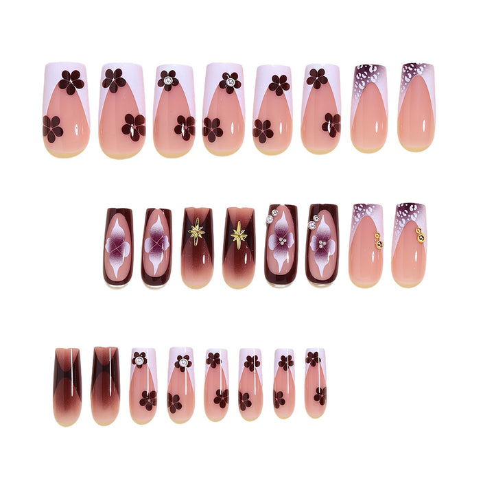 Artistic Acrylic Nail Design Set with Floral and Gold Accents Bowlift