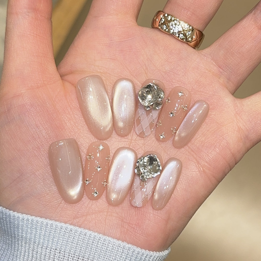 Elegant artificial nails with shimmering effects and rhinestone accents Bowlift