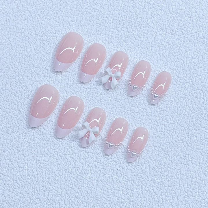 Elegant artificial nails with curved tips and decorative bows Bowlift