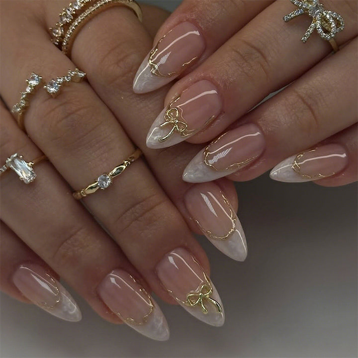 Artificial nails with elegant tip decorations and golden accents Bowlift