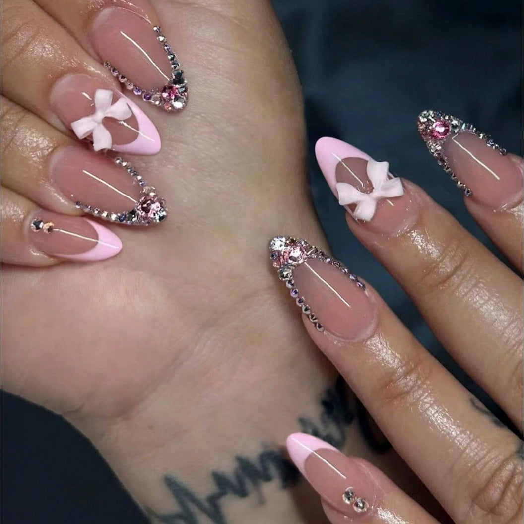 Acrylic nail set with elegant 3D bows and sparkling rhinestone embellishments Bowlift