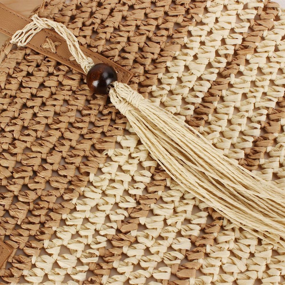 Handbag made of braided natural material with decorative tassel pendant Bowlift