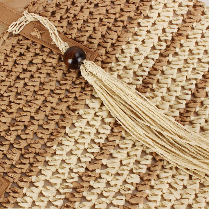 Handbag made of braided natural material with decorative tassel pendant Bowlift