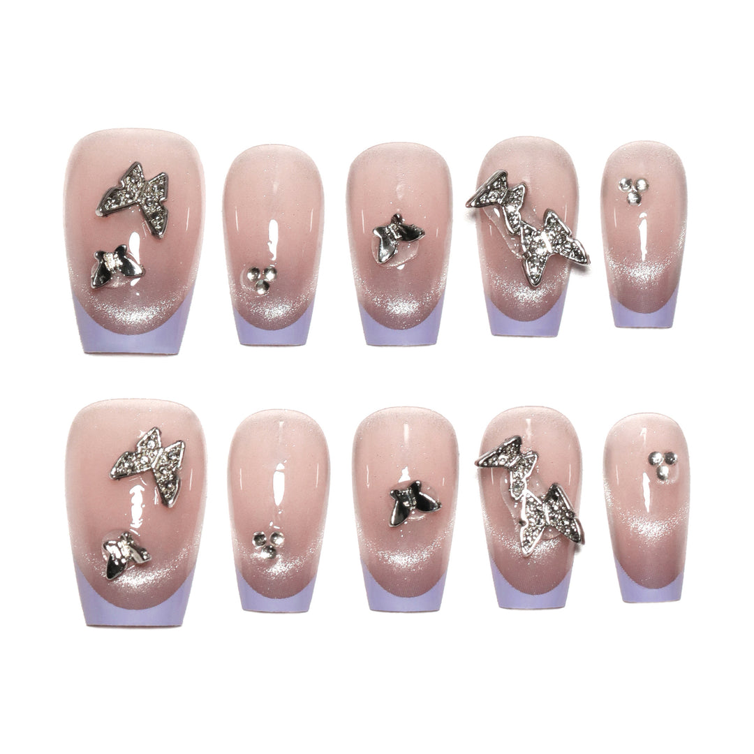 Artificial nail extensions with glitter design and elegant accents Bowlift