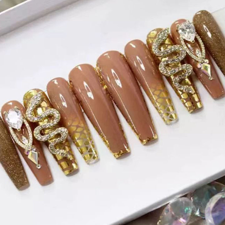 Exclusive stiletto artificial nails with glitter and jewelry accents Bowlift