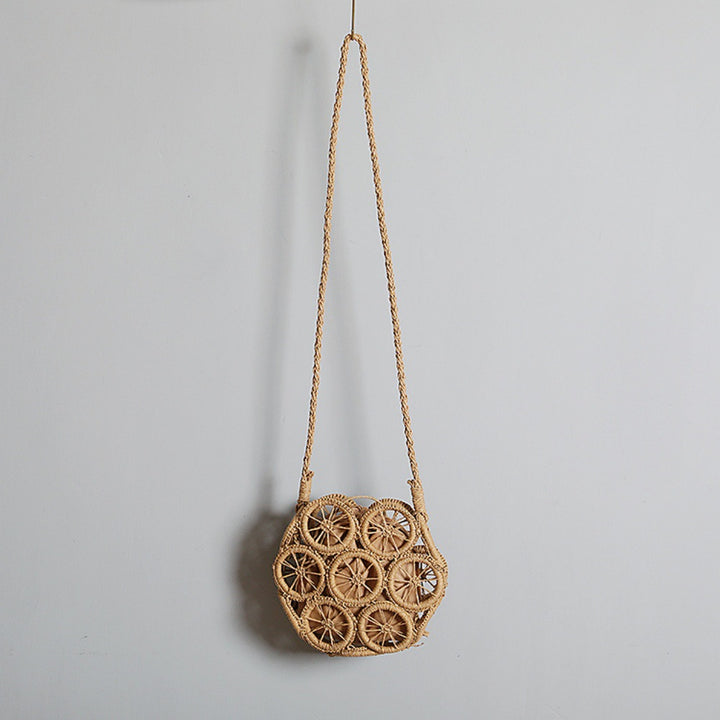 Shoulder bag made of handwoven raffia with intricate embellishments Bowlift