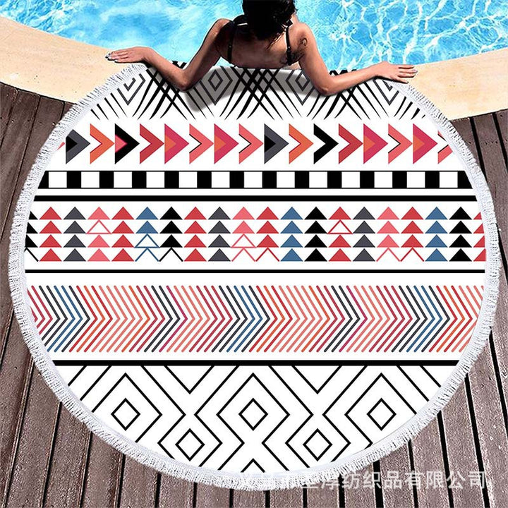 Round beach towel with colorful, tropical floral pattern and fringe decoration Bowlift