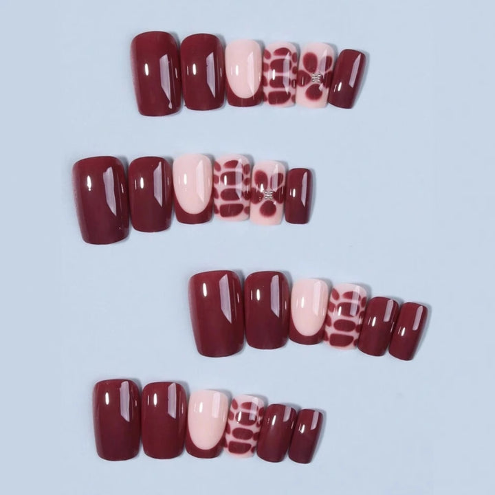 Artificial nail set with elegant geometric designs and accentuating rhinestone details Bowlift