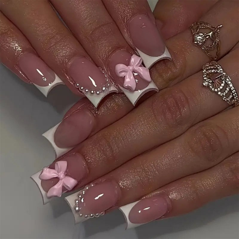 Exclusive artificial nails with decorative bows and pearl details Bowlift