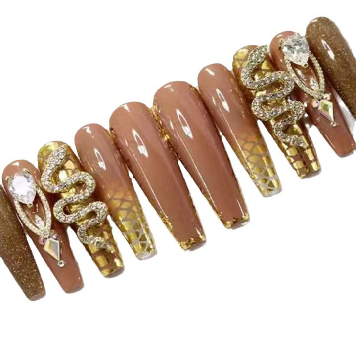 Exclusive stiletto artificial nails with glitter and jewelry accents Bowlift