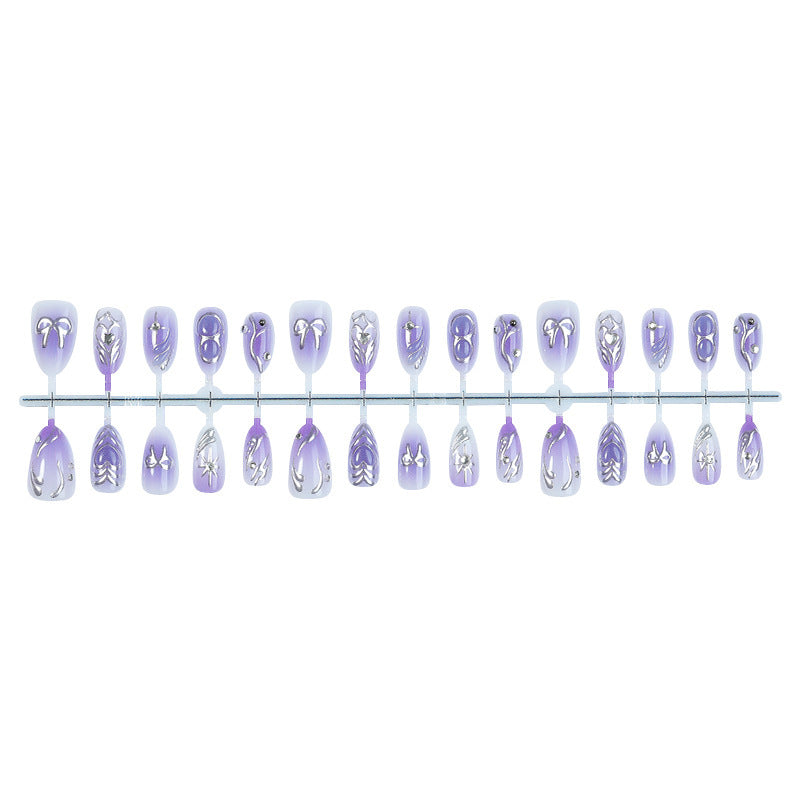 Acrylic nail set with elegant ombre design and delicate embellishments Bowlift