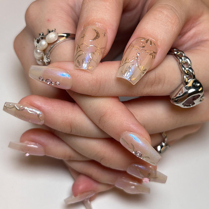 Artificial nail art with elegant rhinestone and glitter effects Bowlift