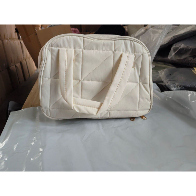 Cosmetic bag with padded interior compartment Bowlift
