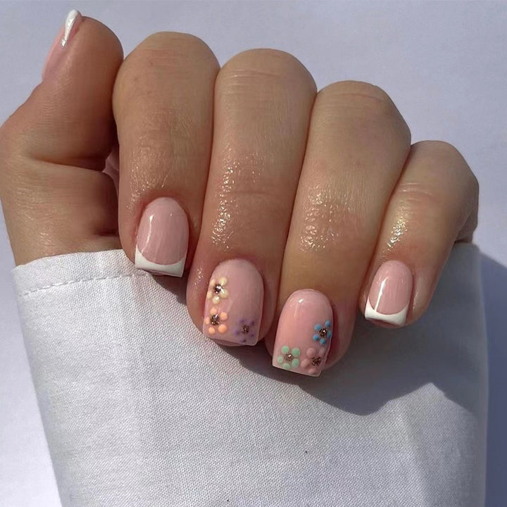 Artistic nail art with floral accent and elegant French tip Bowlift