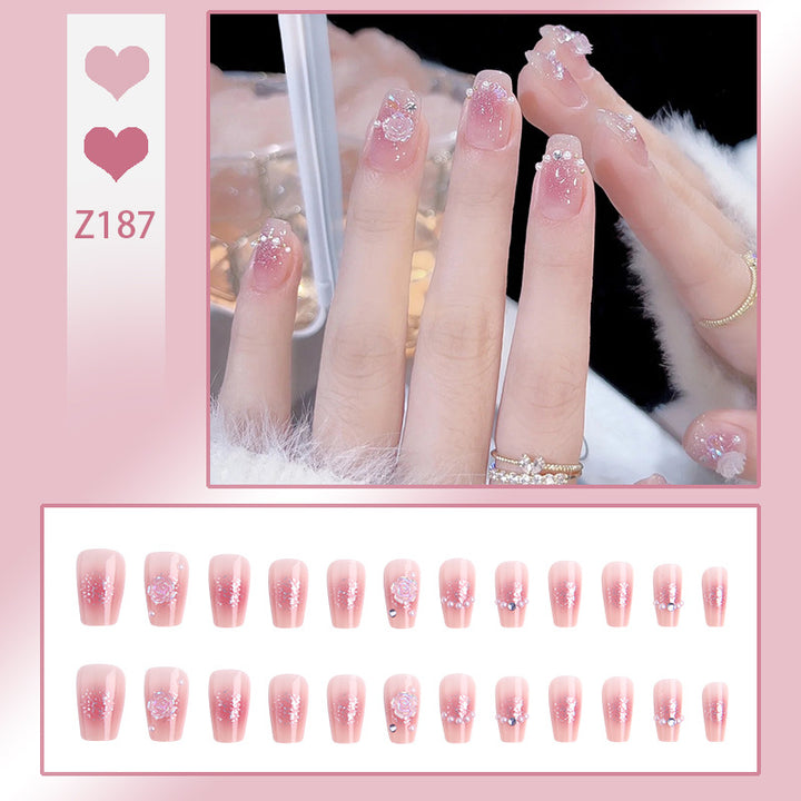 Artificial nail set with sparkling glitter and pearl decorations Bowlift