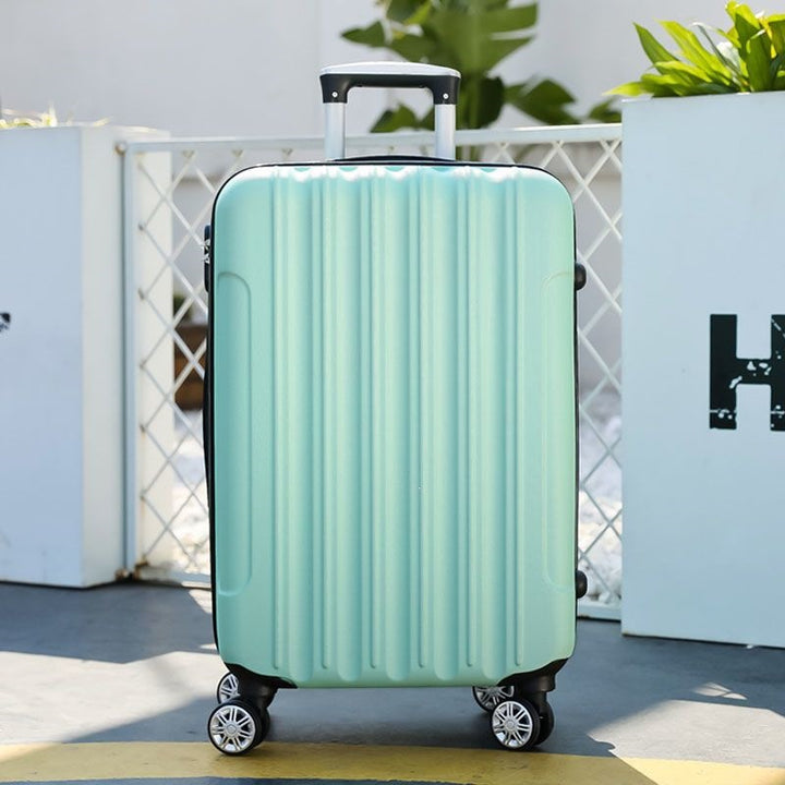 Hard shell suitcase with 360-degree wheel system and integrated safety feature Bowlift