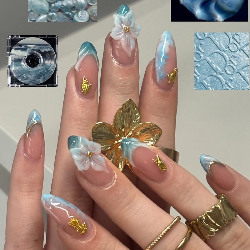 Creative nail set with elegant gold embellishments Bowlift
