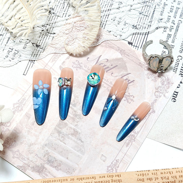 Artificial nails in elegant design with artistic decorations and glitter accents Bowlift