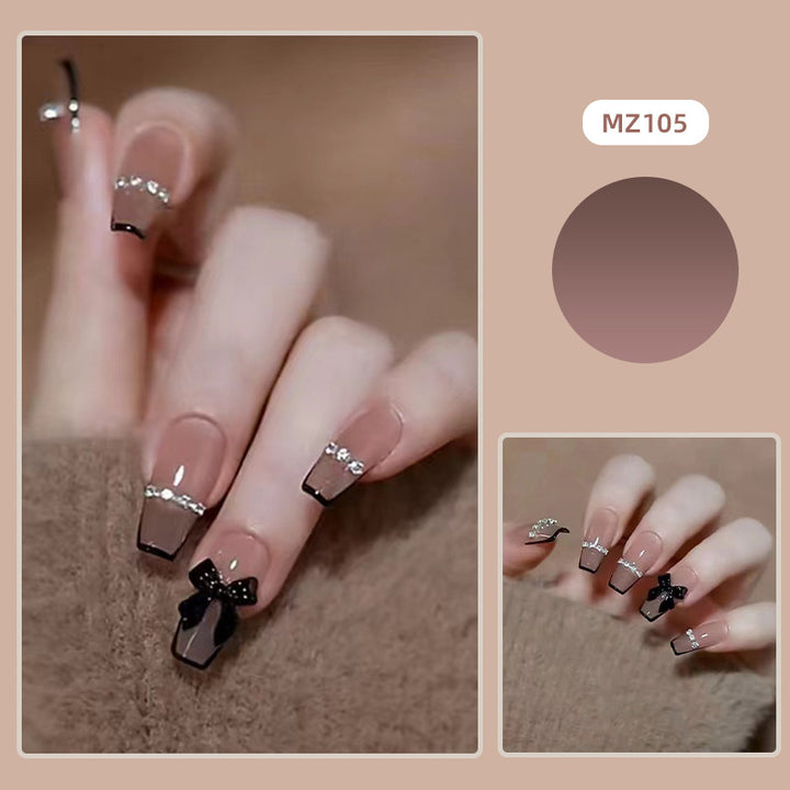 Elegant nail design with bow and rhinestone details Bowlift