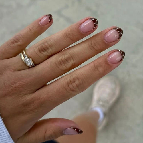 Artful nail art with elegant French tips and glitter accents Bowlift