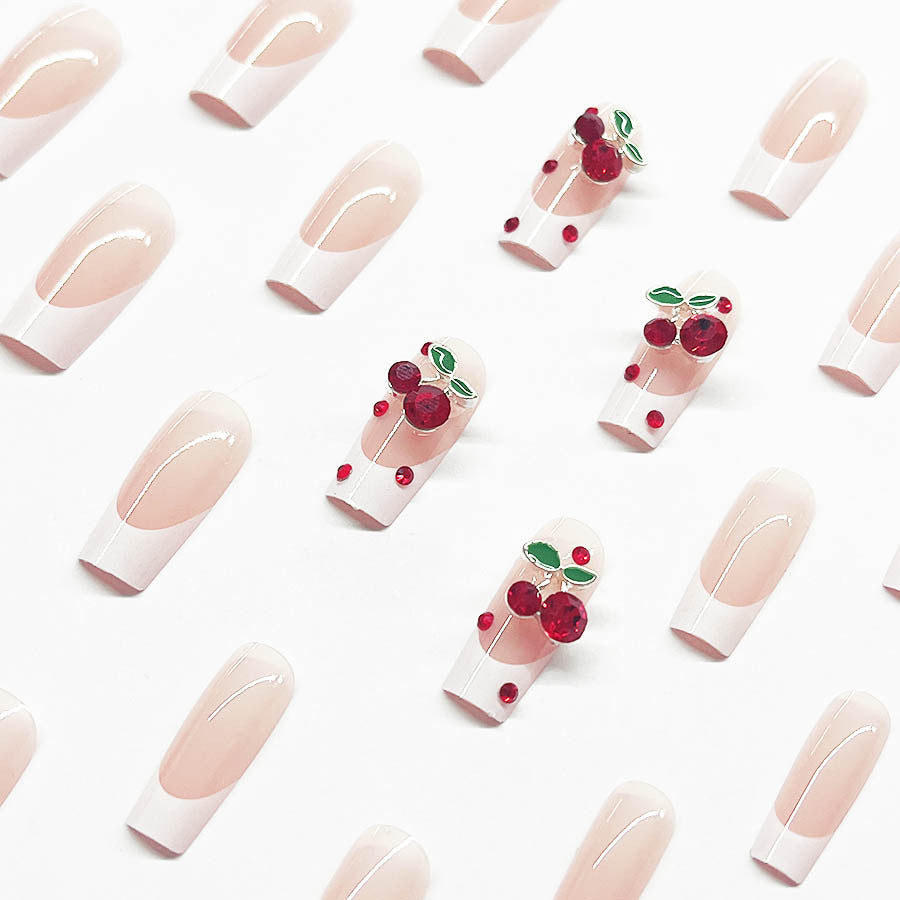 Acrylic nail set with chic cherry motifs and elegant French tip Bowlift