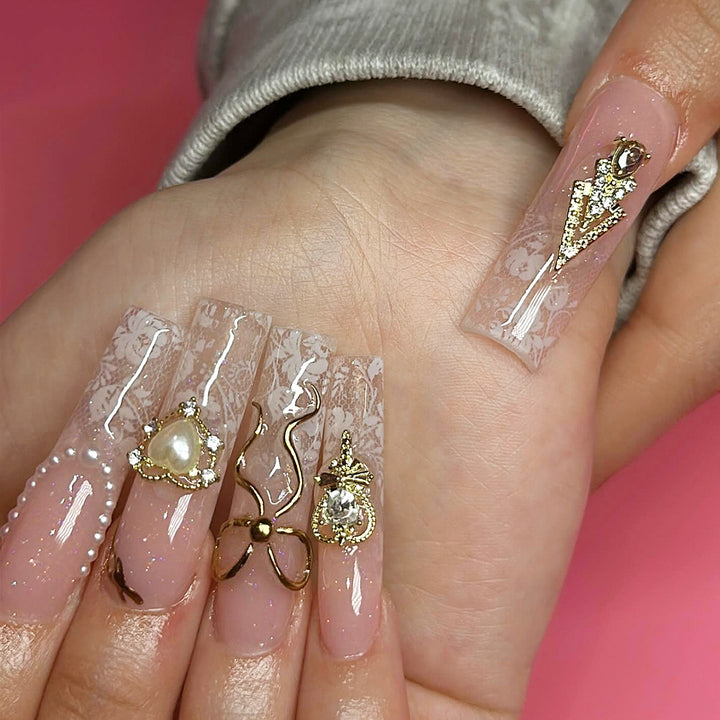 Artistic Long Nails with Elegant Gold Accents Bowlift
