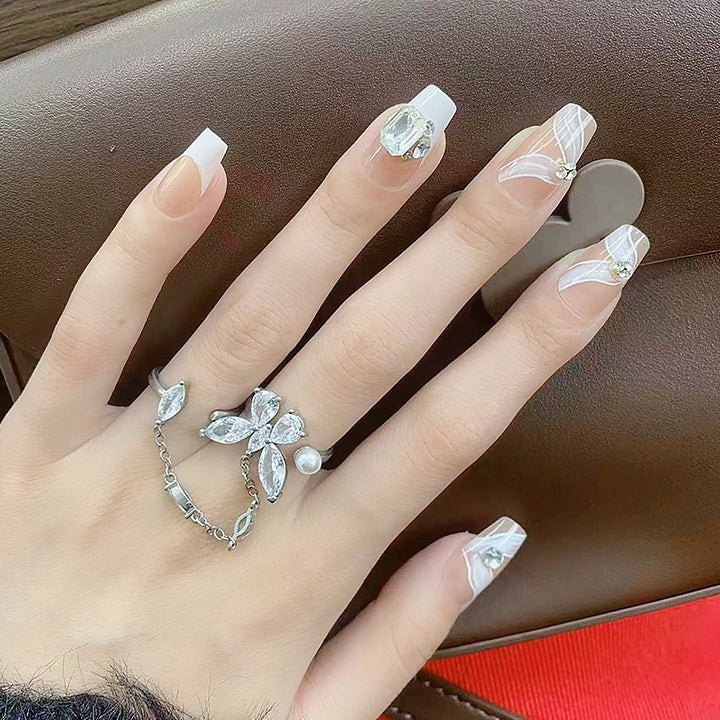 Elegant artificial nail set with delicate decorations and glitter elements Bowlift