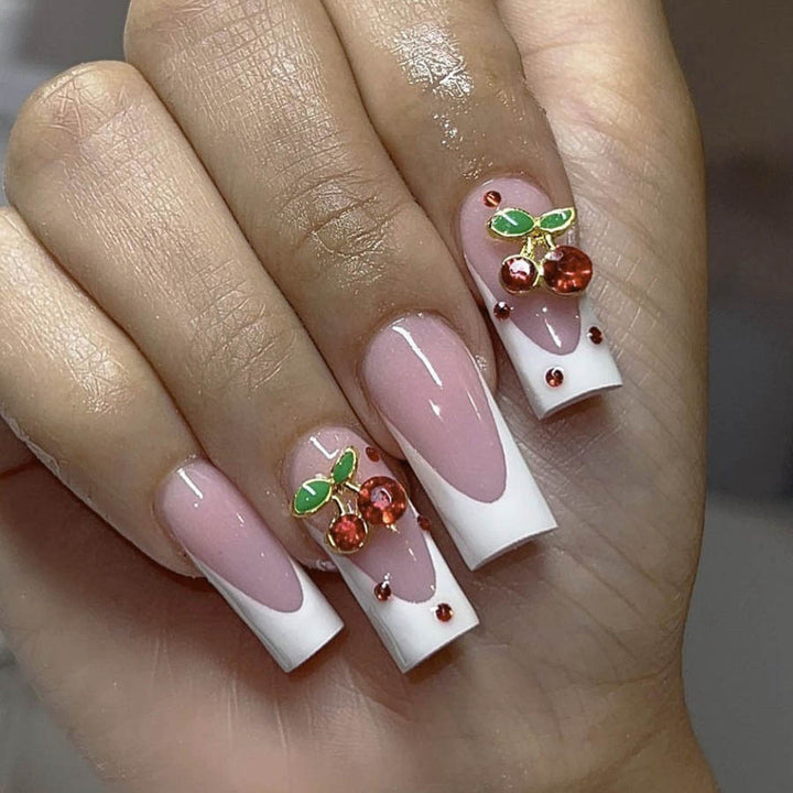 Acrylic nail set with chic cherry motifs and elegant French tip Bowlift