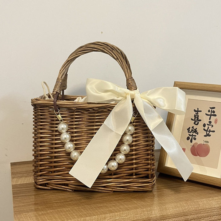 Ladies' basket bag with decorative pearl accents and bow decoration Bowlift